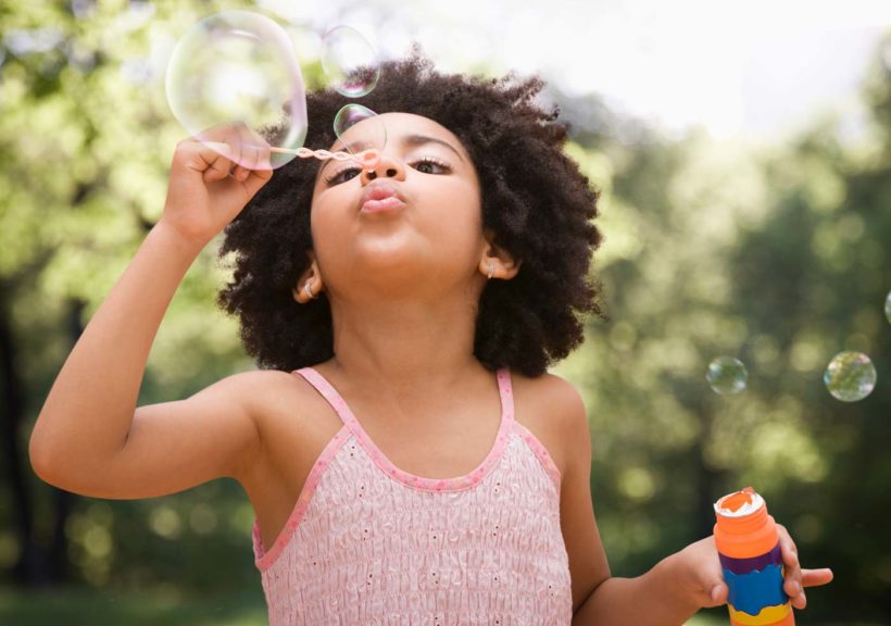 girl blowing bubbles