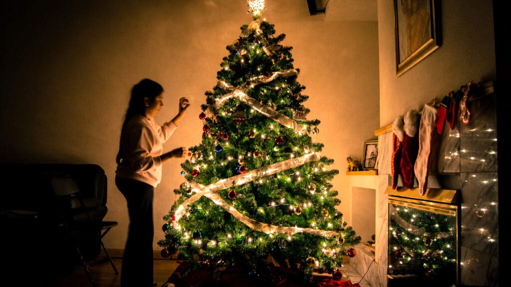 girl-christmas-tree-fireplace-decorations-standing