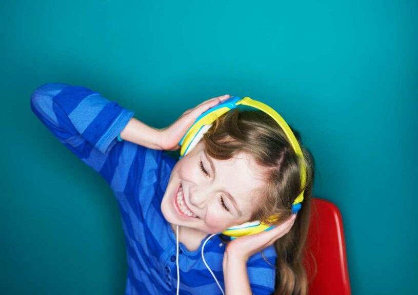 Happy girl listening to music on headphones