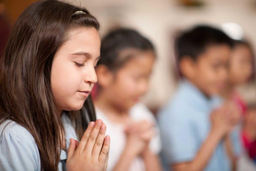 Girl praying in Sunday School Class