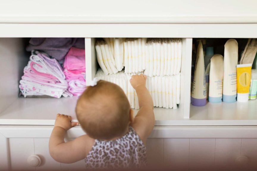 girl reaching for diaper