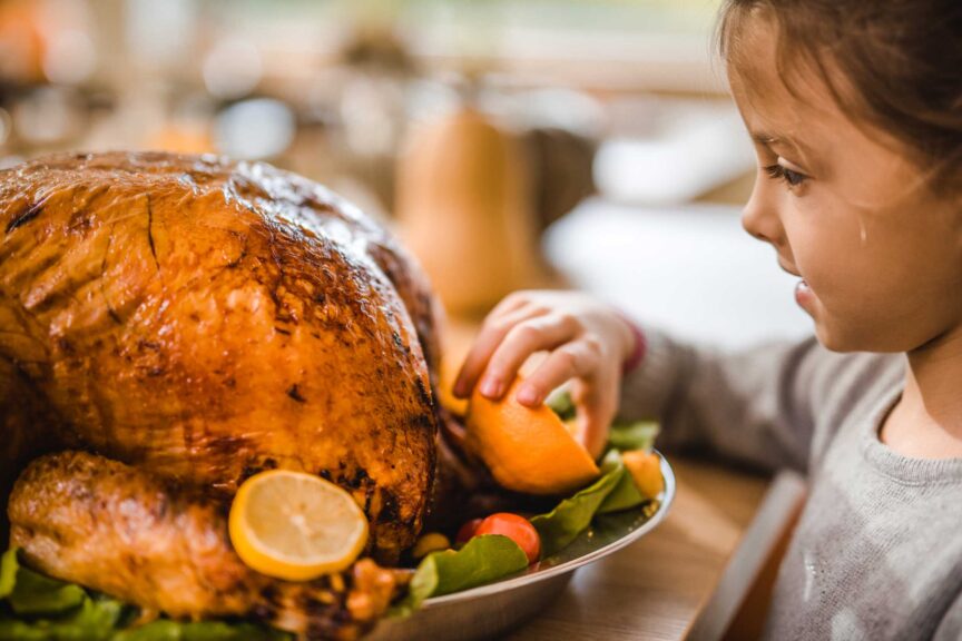 happy girl decorating turkey thanksgiving