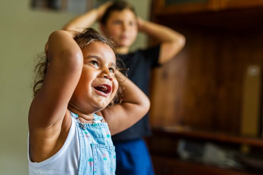 Happy Young Australian Aboriginal Girl Learning to Sing and Dance to a Song