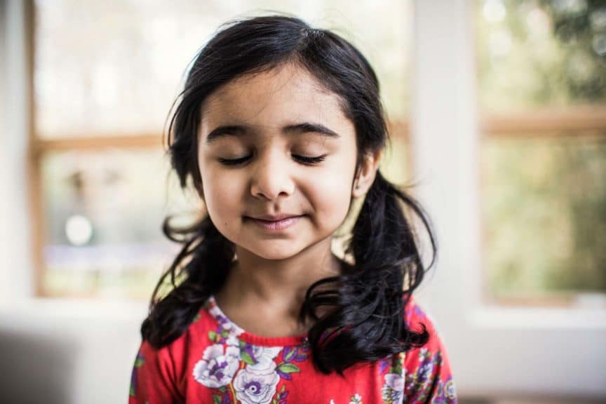 Portrait of hopeful young girl at home