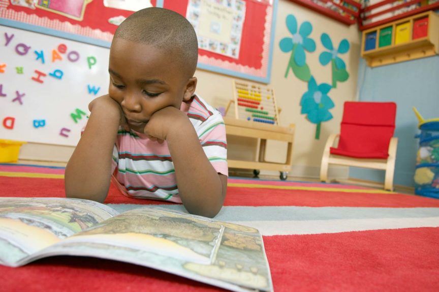 kid reading on floor