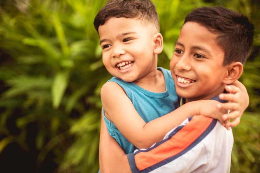 Sibling Kids happy hugging