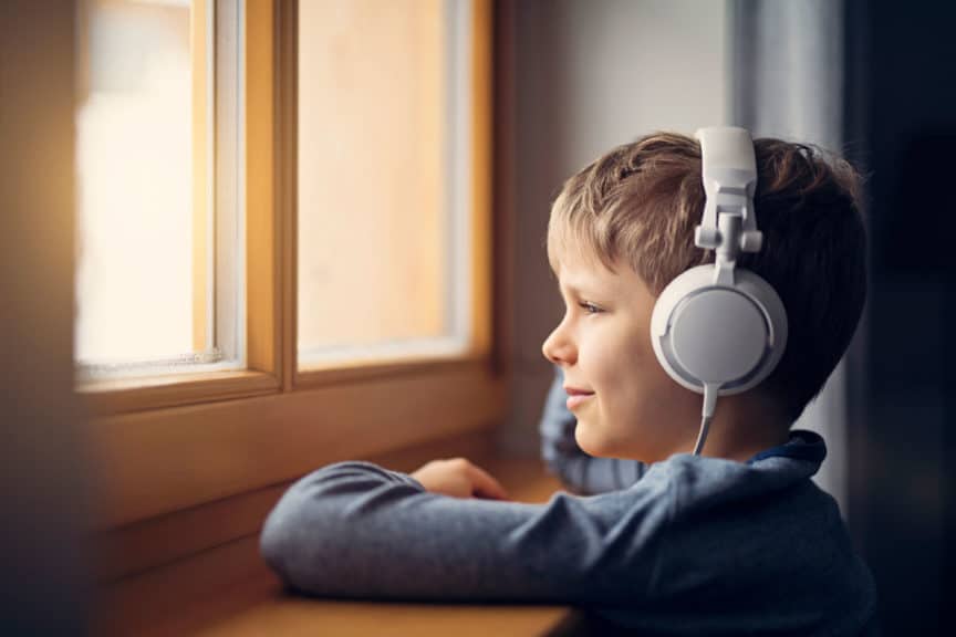 Little boy in headphones listening to music