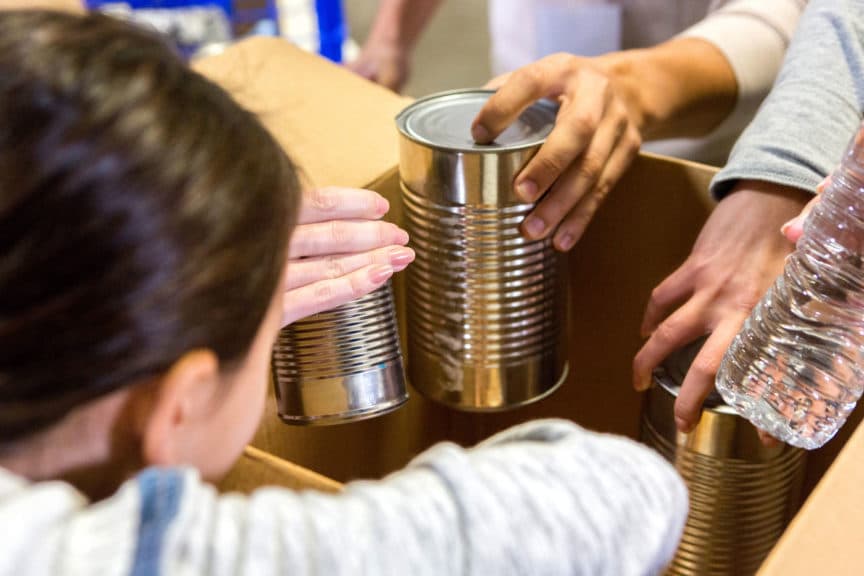 Little girl donates canned goods during food drive