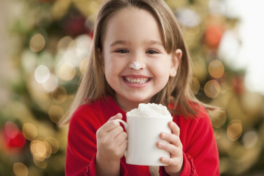 little girl drinking hot coco christmas