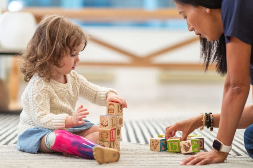 Little girl with prosthetic leg at occupational therapy appointment