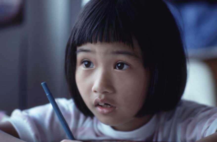 little-girl-writing-looks-concerned-worried