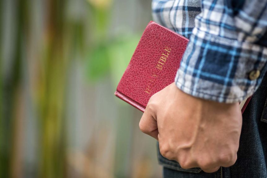 man holding Bible