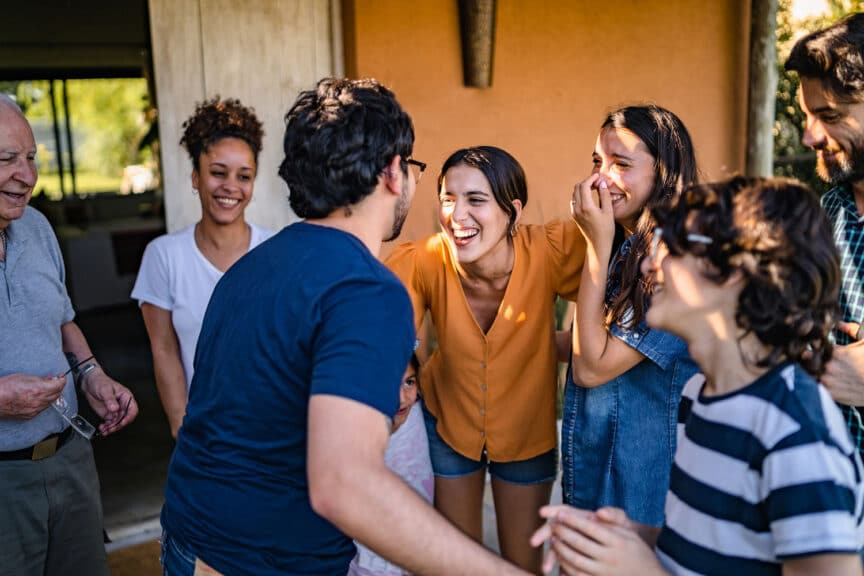 A group of Children's ministry volunteers talk and laugh together.