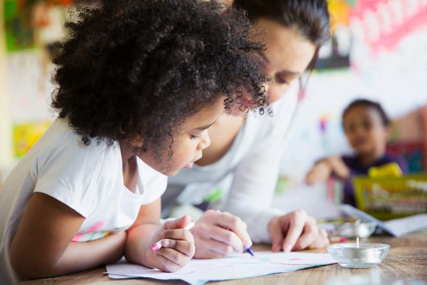 woman and curious little girl coloring