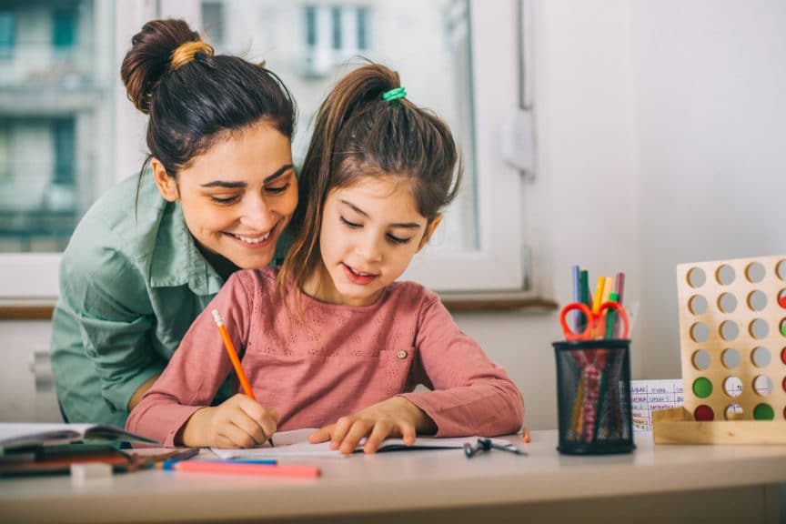 Mother Helping Her Daughter While Studying at home