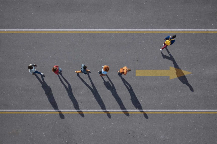 People walking in line on road, painted on asphalt, one person walking off