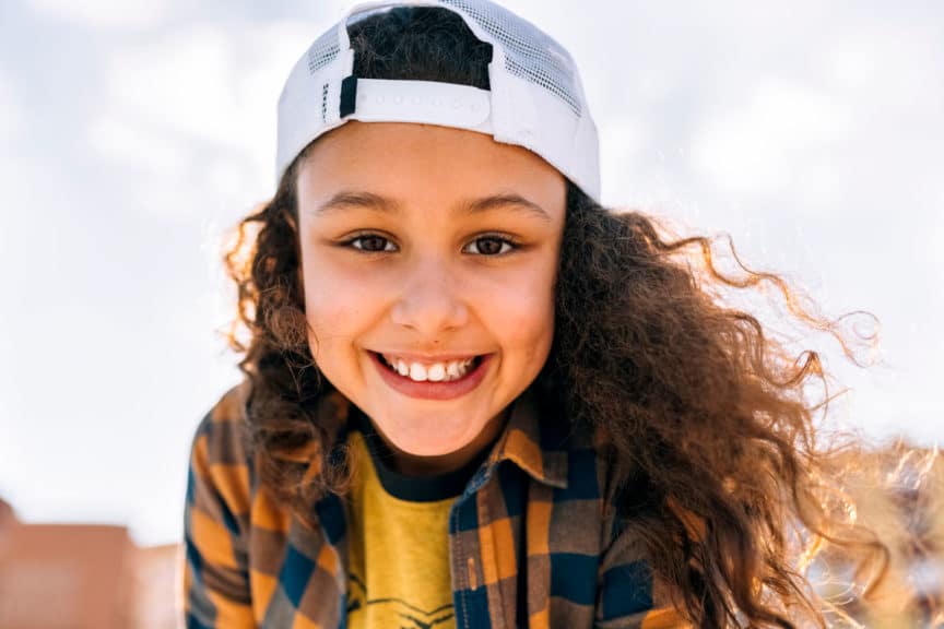 Portrait of happy girl wearing baseball cap