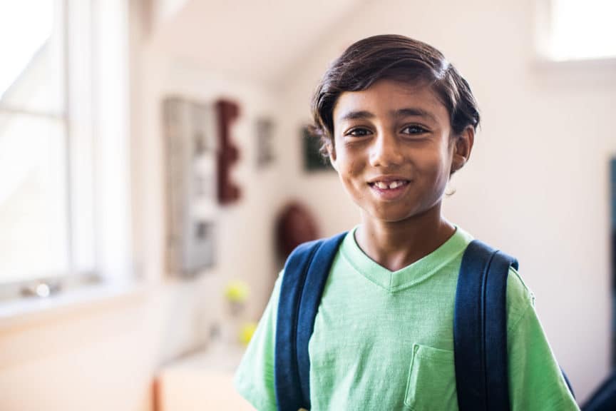 Portrait of schoolboy in his bedroom