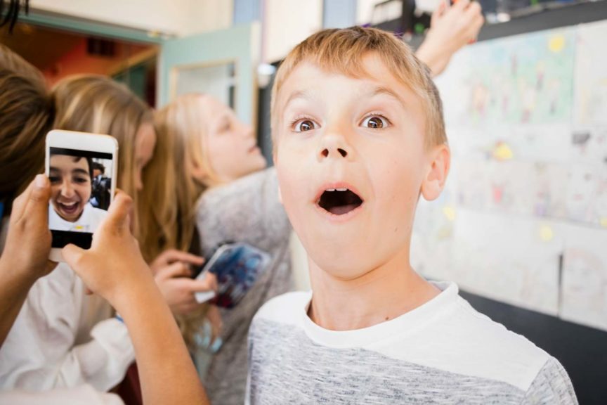 surprised boy taking a selfie with friends