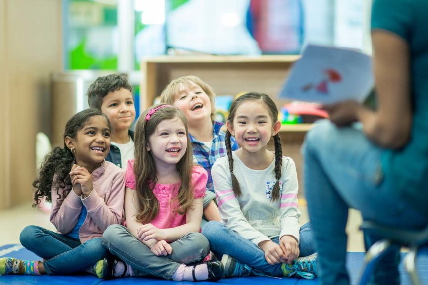 teacher reading to students volunteer excitement