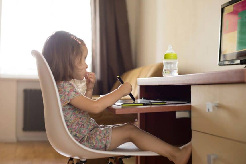 toddler girl using digital tablet for drawing and learning shapes