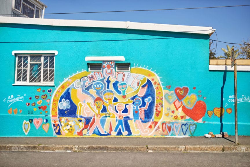 Vibrant community mural on sunny urban wall 