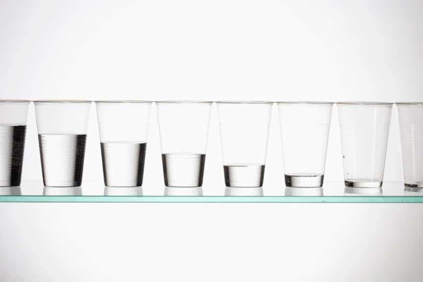 A row of glasses with varying amounts of water