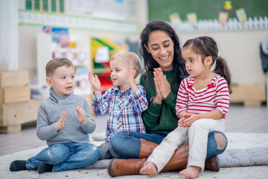 woman clapping to music with small children