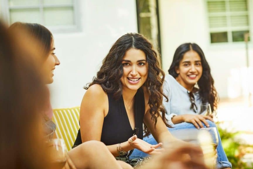 Beautiful woman talking during social gathering