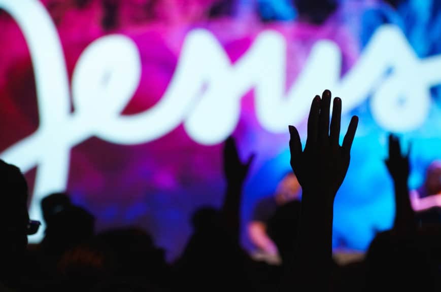 Hands up during worship with Jesus sign