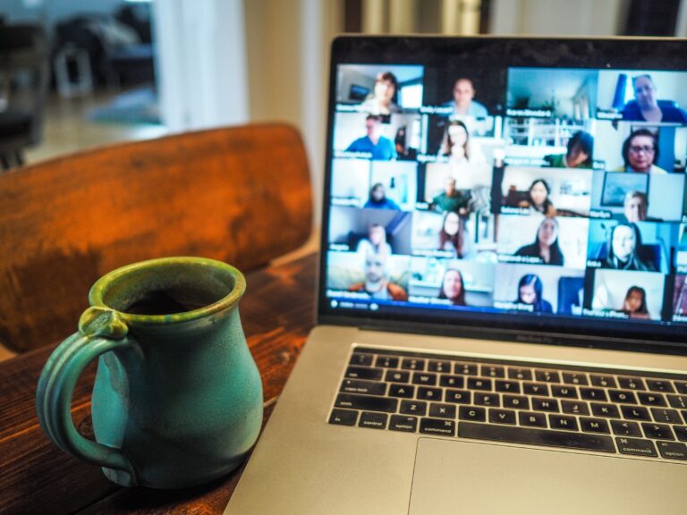 Zoom meeting  on a computer with a coffee mug in the kitchen